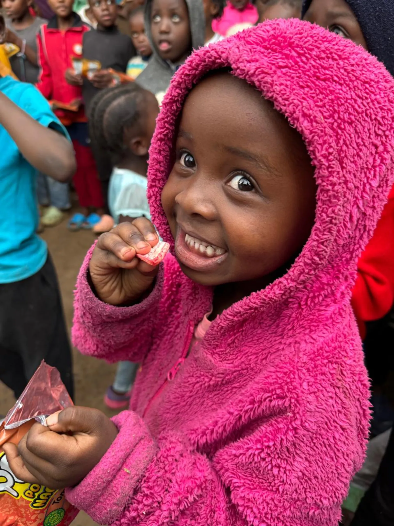 A child smiling during a feeding programme in Kangemi