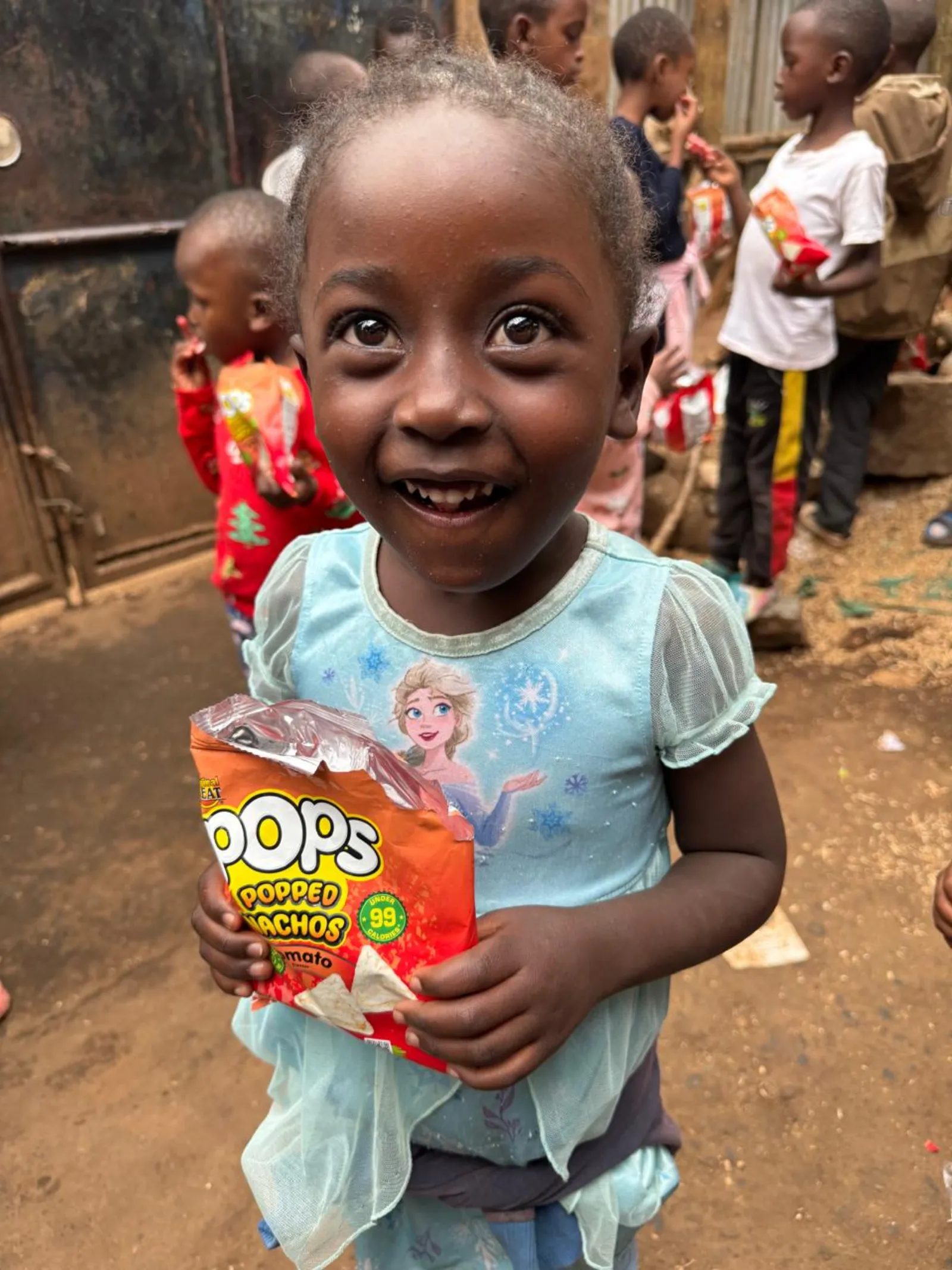 A young girl smiling at a Risingh feeding day