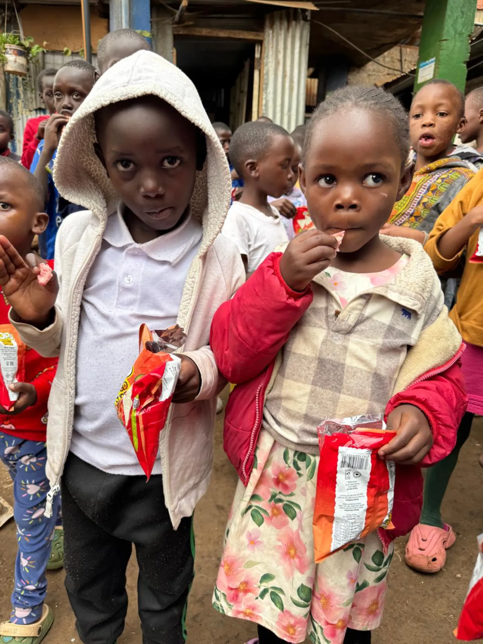 Children receiving a meal at a Risingh outreach